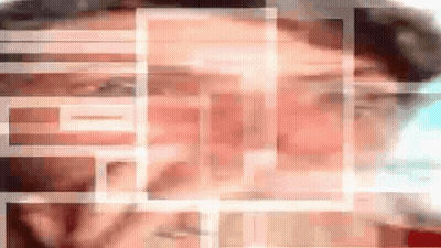 A Blurry Picture Of A Man 'S Face With A Grid Of Squares Surrounding It GIF