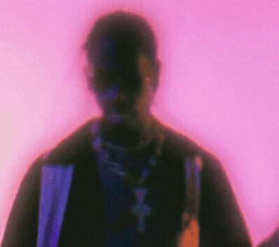 A Blurry Picture Of A Man 'S Face With A Purple Background . GIF