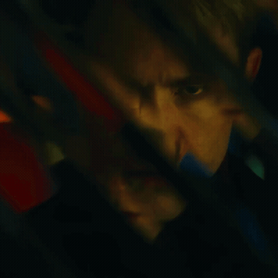 A Blurry Picture Of A Man 'S Face With A Red And Blue Background GIF