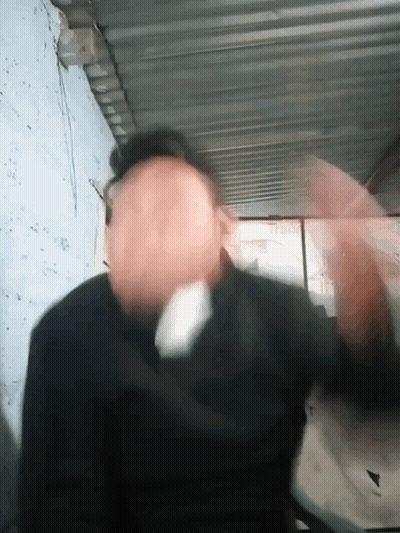 A Blurry Picture Of A Man 'S Face With A Sign Behind Him That Says ' A ' GIF