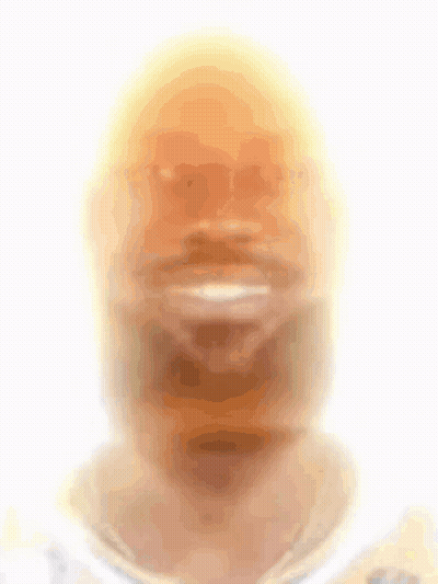 A Blurry Picture Of A Man 'S Face With A Yellow Hat On GIF