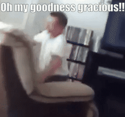 A Blurry Picture Of A Man Sitting In A Chair With The Caption Oh My Goodness Gracious ! GIF
