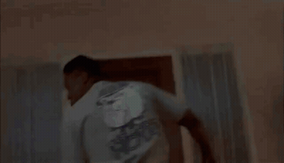 A Blurry Picture Of A Man Sitting On A Bed With His Eyes Closed . GIF