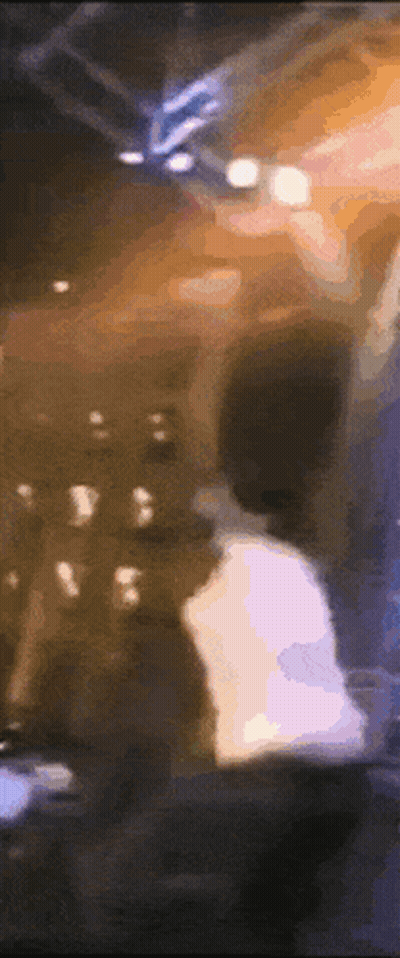 A Blurry Picture Of A Man Standing In Front Of A Crowd Of People . GIF