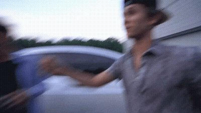 A Blurry Picture Of A Man Standing Next To Another Man GIF