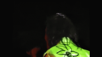 A Blurry Picture Of A Man Talking To Another Man In A Yellow Jacket . GIF