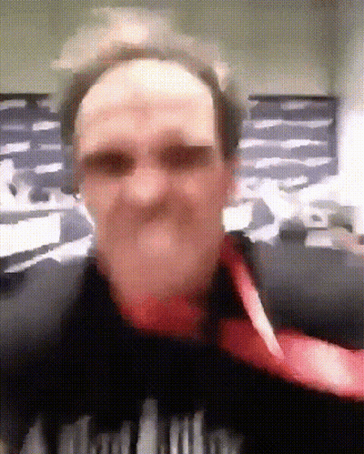 A Blurry Picture Of A Man Wearing A Black Shirt That Says ' A ' On The Front GIF