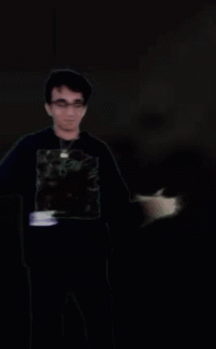 A Blurry Picture Of A Man Wearing A Black Shirt With A Picture Of A Man On It GIF