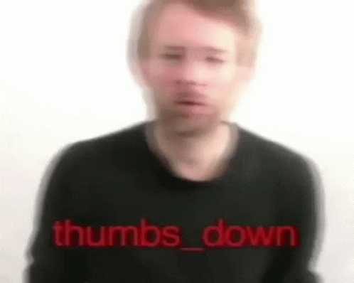 A Blurry Picture Of A Man Wearing A Black Sweater With The Words `` Thumbs Down '' Written In Red . GIF