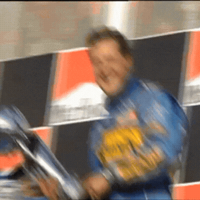 a blurry picture of a man wearing a blue jacket with a yellow sticker on it