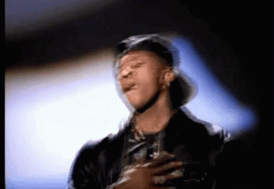 A Blurry Picture Of A Man Wearing A Hat And A Jacket GIF