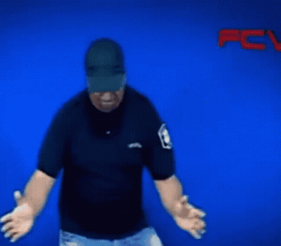 A Blurry Picture Of A Man Wearing A Hat And A Police Badge GIF