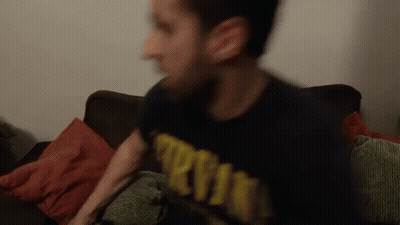 A Blurry Picture Of A Man Wearing A Shirt That Says ' Army ' On It GIF