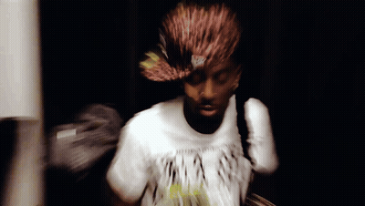 A Blurry Picture Of A Man Wearing A T-Shirt That Says ' A ' On It GIF