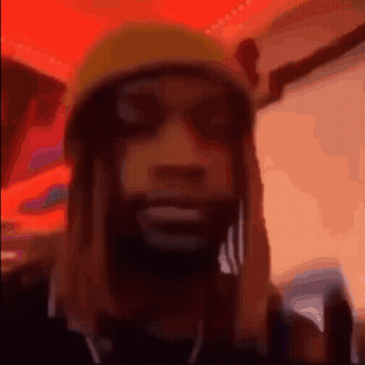 A Blurry Picture Of A Man Wearing A Yellow Beanie GIF