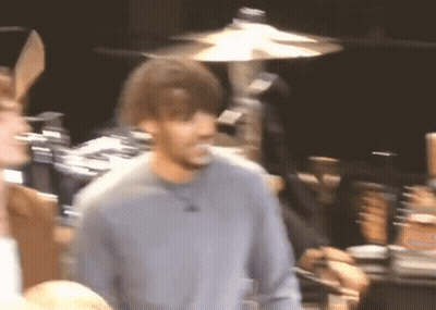A Blurry Picture Of A Man Wearing Bunny Ears In Front Of A Drum Set GIF