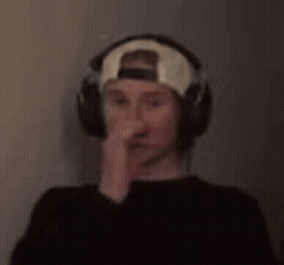 a blurry picture of a man wearing headphones and a baseball cap .