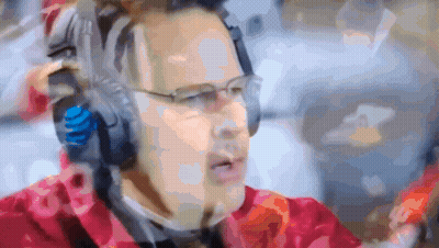 A Blurry Picture Of A Man Wearing Headphones And A Headset With The Number 18 On It GIF