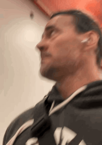 A Blurry Picture Of A Man Wearing Headphones And A Hoodie GIF