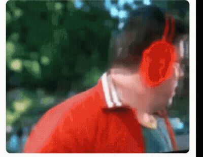 A Blurry Picture Of A Man Wearing Headphones And A Red Jacket GIF