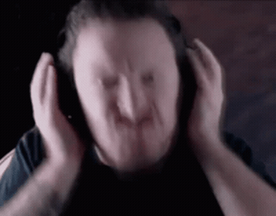 A Blurry Picture Of A Man Wearing Headphones . GIF