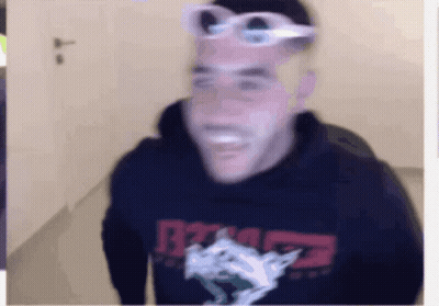 A Blurry Picture Of A Man Wearing Sunglasses And A Hoodie That Says R7 On It GIF