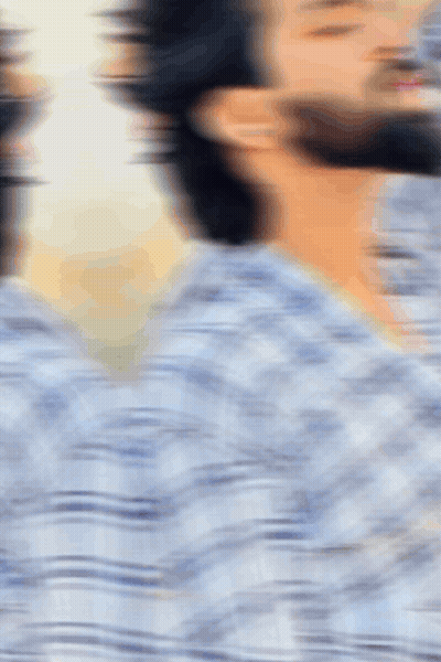 A Blurry Picture Of A Man With A Beard In A Plaid Shirt GIF