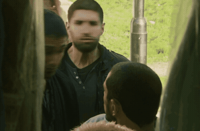 A Blurry Picture Of A Man With A Beard Standing Next To Another Man GIF