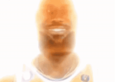 A Blurry Picture Of A Man With A Beard Wearing A White Jersey With A Eagle On It GIF