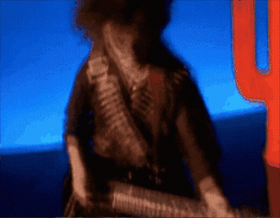 A Blurry Picture Of A Man With A Gun And A Cactus In The Background GIF