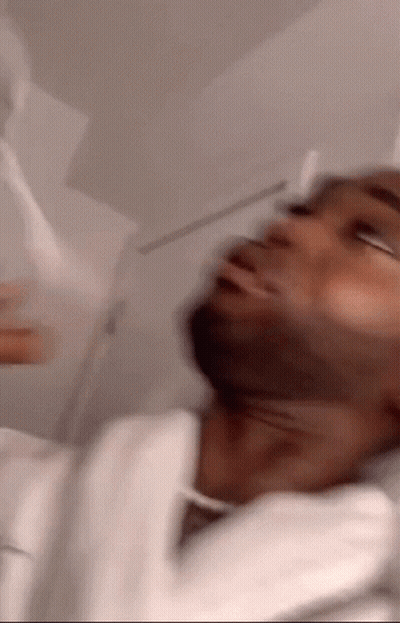 A Blurry Picture Of A Man With A White Robe On GIF