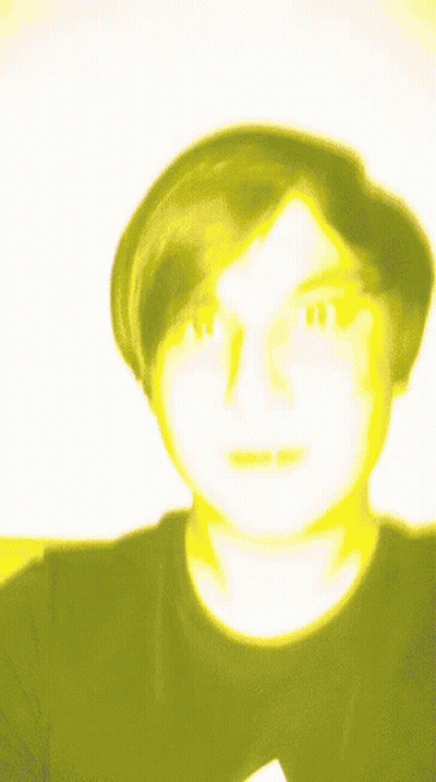 A Blurry Picture Of A Man With A Yellow Face GIF
