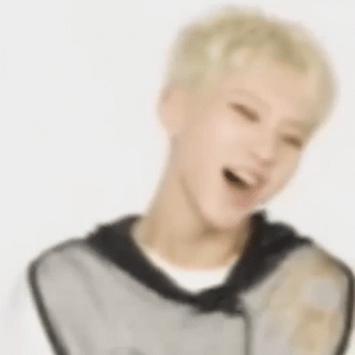 A Blurry Picture Of A Man With Blonde Hair Laughing . GIF