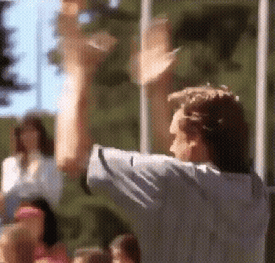 A Blurry Picture Of A Man With His Arms Up GIF