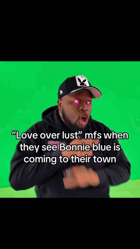 A Blurry Picture Of A Man With Pink Eyes And The Words " Love Over Lust " On His Face . GIF