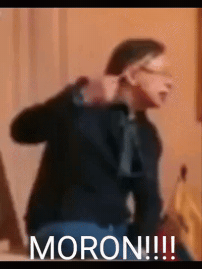 A Blurry Picture Of A Man With The Word Moron Written On The Bottom GIF