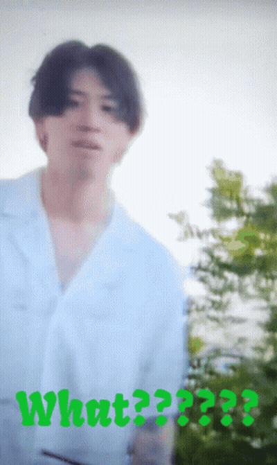 A Blurry Picture Of A Man With The Word What Written In Green GIF