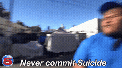 A Blurry Picture Of A Man With The Words " Never Commit Suicide " On The Bottom GIF