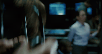 A Blurry Picture Of A Person Holding A Cell Phone In A Dark Room GIF