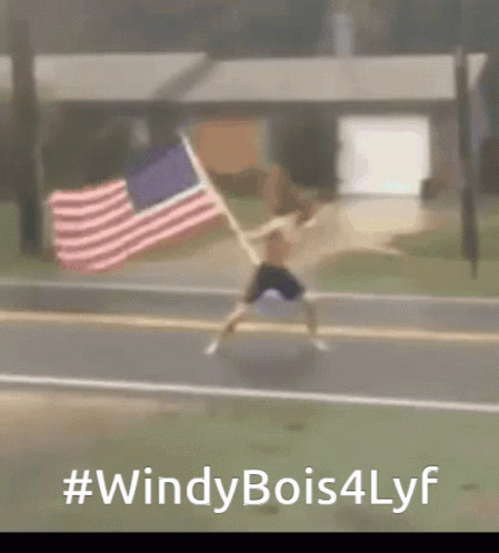 A Blurry Picture Of A Person Holding An American Flag With # Windy Bois4lyf Written Below It GIF