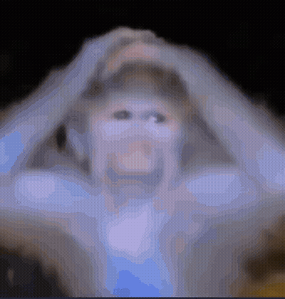 A Blurry Picture Of A Person Holding Their Head With Their Hands GIF