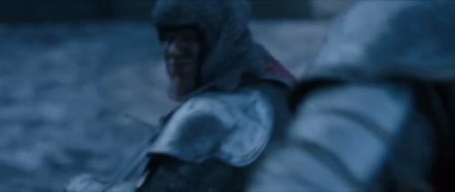 A Blurry Picture Of A Person In A Hooded Jacket In The Snow GIF
