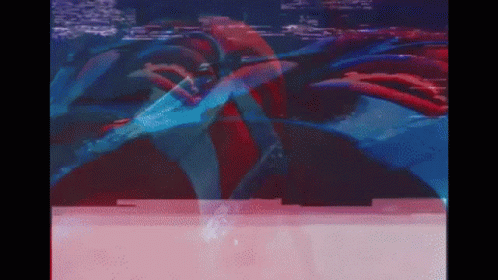 A Blurry Picture Of A Person In A Red And Blue Suit GIF