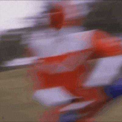 A Blurry Picture Of A Person In A Red And White Uniform GIF