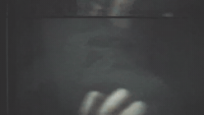 A Blurry Picture Of A Person Looking Out Of A Window GIF