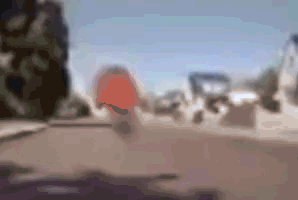 A Blurry Picture Of A Person Riding A Bike On A Street . GIF