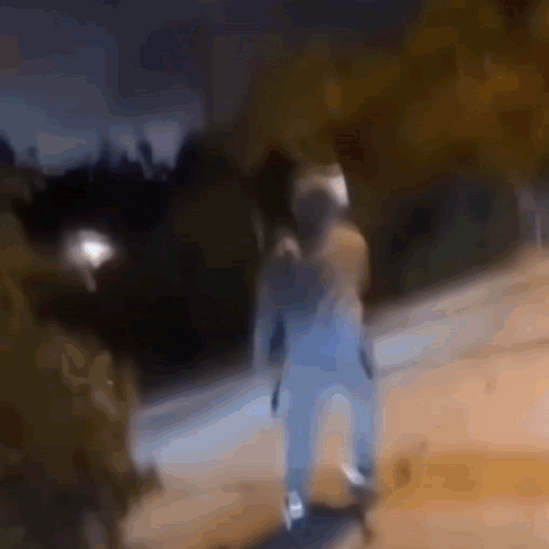 A Blurry Picture Of A Person Riding A Skateboard On A Sidewalk At Night . GIF