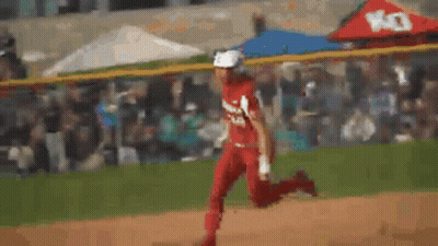 A Blurry Picture Of A Person Running On A Baseball Field . GIF