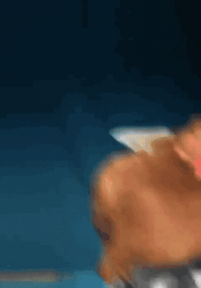 A Blurry Picture Of A Person 'S Face Against A Dark Blue Background GIF
