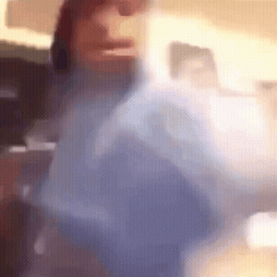 A Blurry Picture Of A Person 'S Face And Shoulder GIF